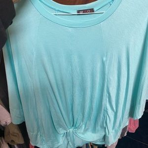 This is a short sleeve oversize shirt that is a baby blue.